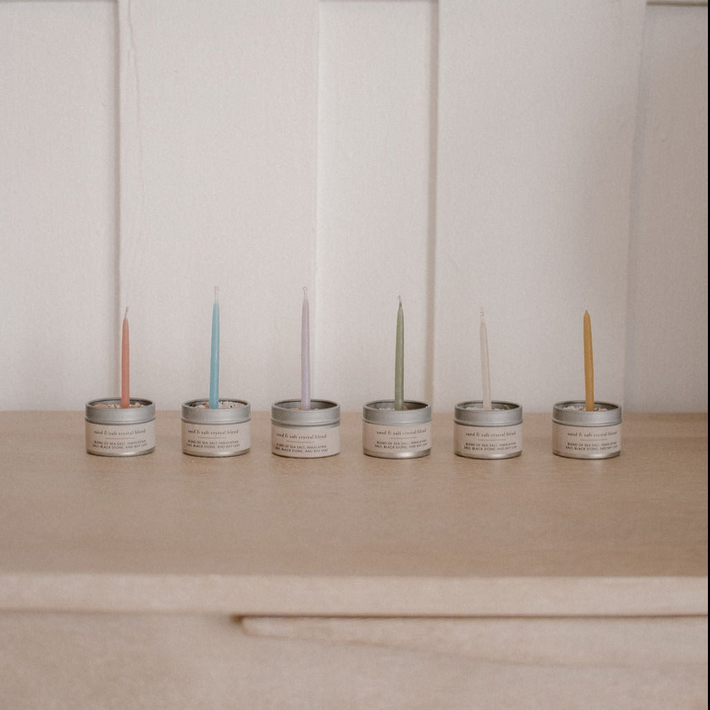 6 different colour candles inside 6 metal salt tins